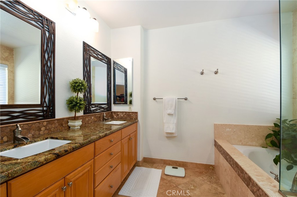41686 Monterey Place Temecula, CA 92591 - Photo 21 of 51 a bathroom with a tub sink and mirror