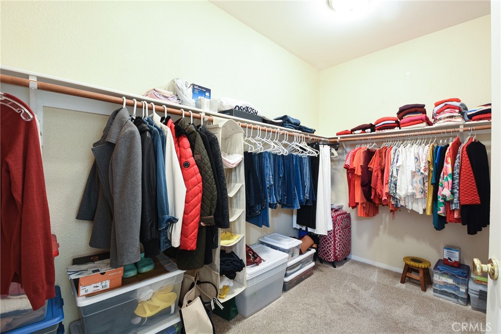 41686 Monterey Place Temecula, CA 92591 - Photo 23 of 51 a view of walk in closet with clothes