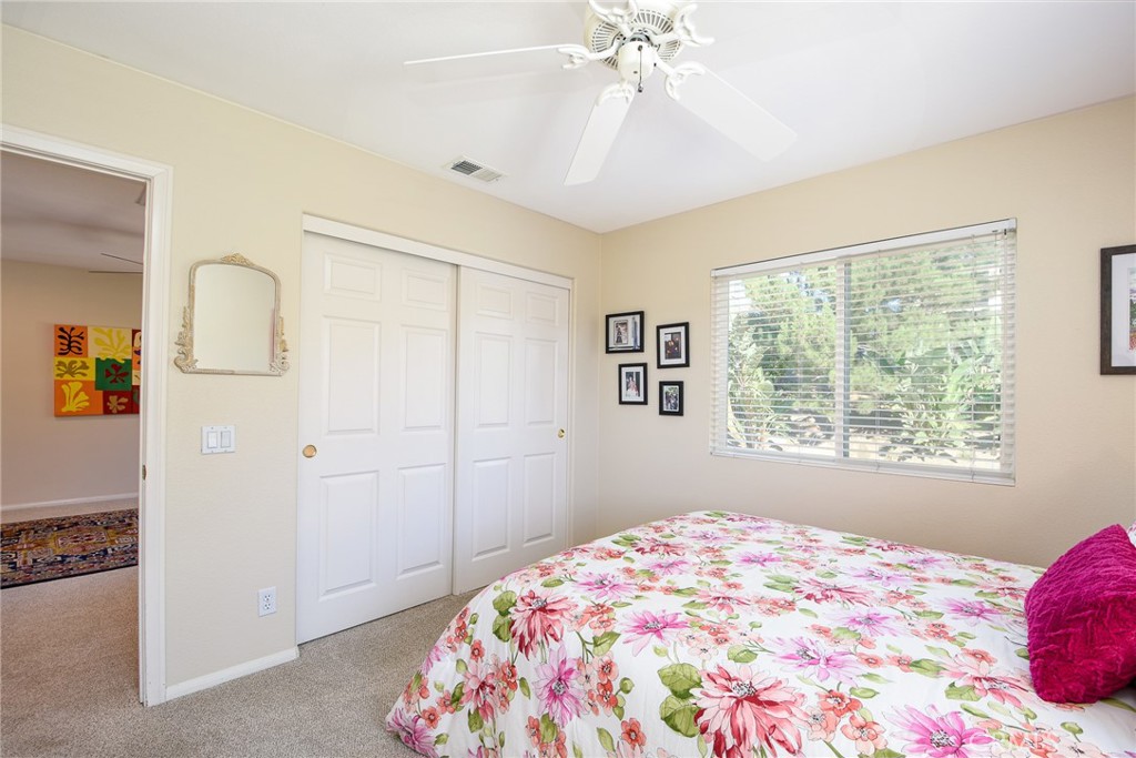 41686 Monterey Place Temecula, CA 92591 - Photo 31 of 51 a bedroom with a bed and a chandelier