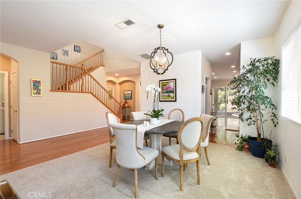 41686 Monterey Place Temecula, CA 92591 - Photo 8 of 51 a view of a dining room with furniture and wooden floor