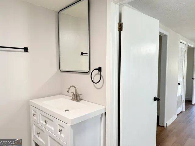 a bathroom with a sink toilet and mirror