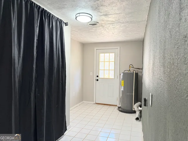 a view of a hallway with closet and window
