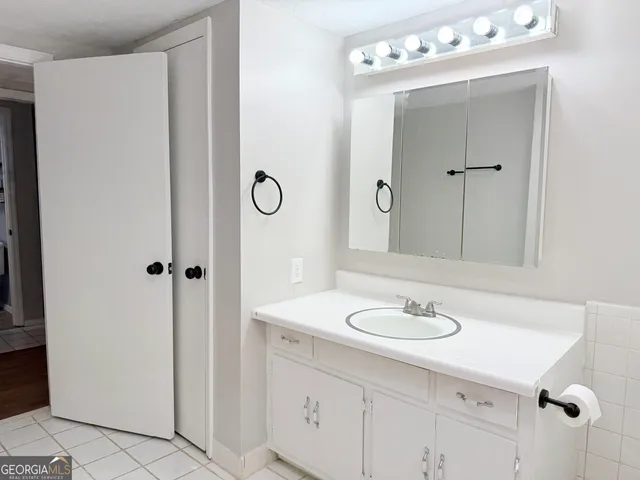 a bathroom with a sink vanity and a mirror