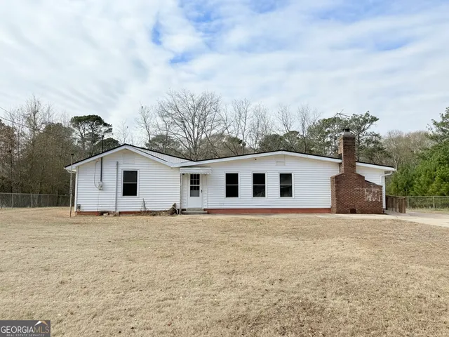 a house with trees in the background
