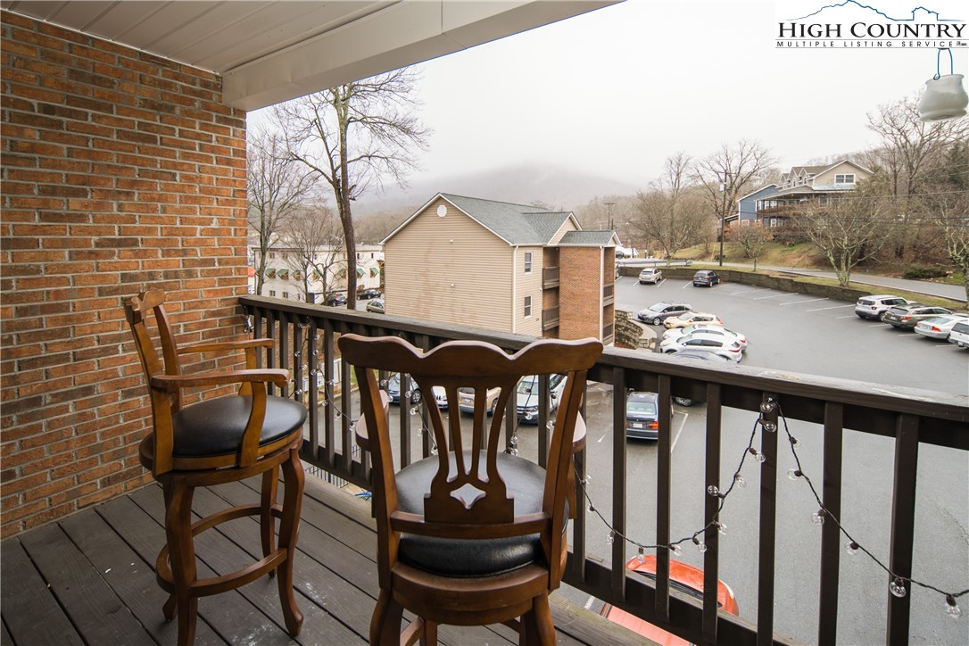 236 Oak Street, Unit H12 Boone, NC 28607 - Photo 13 of 22 a view of a chairs and table in the balcony