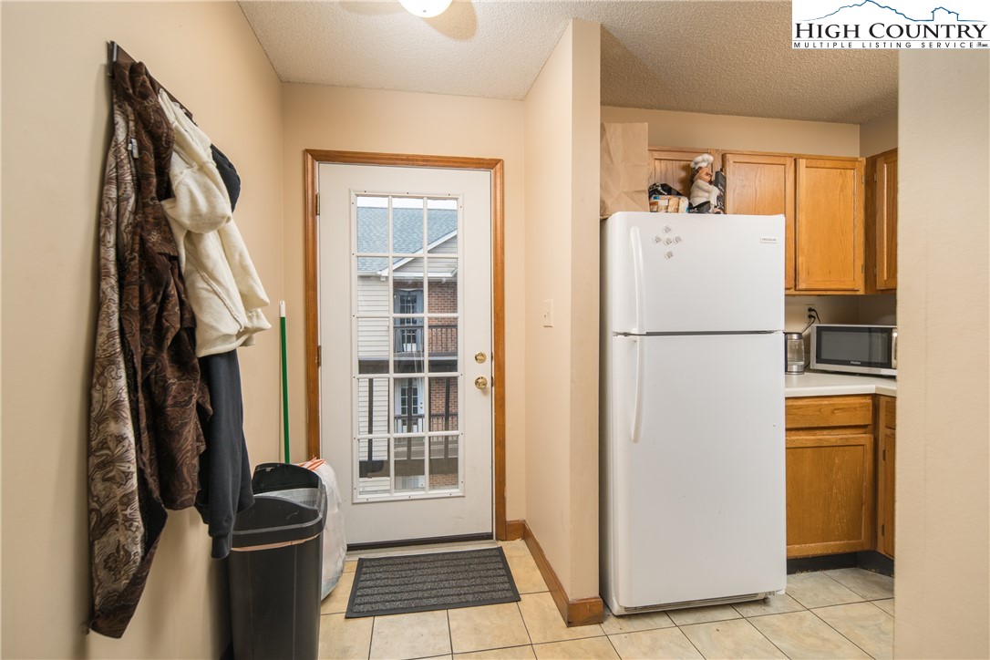 236 Oak Street, Unit H12 Boone, NC 28607 - Photo 6 of 22 a white refrigerator freezer and a stove sitting inside of a kitchen