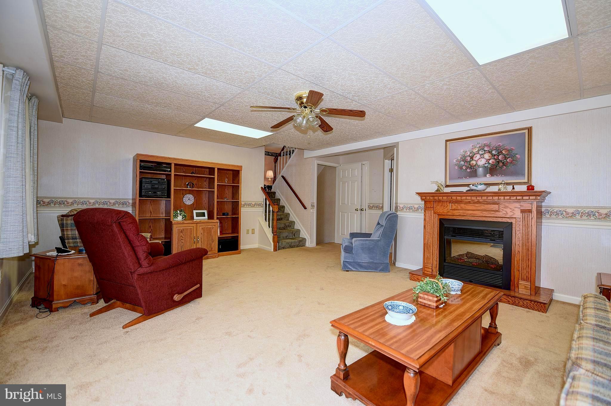 2505 Perring Woods Road Baltimore, MD 21234 - Photo 27 of 44 Lower Level with electric fireplace & ceiling fan