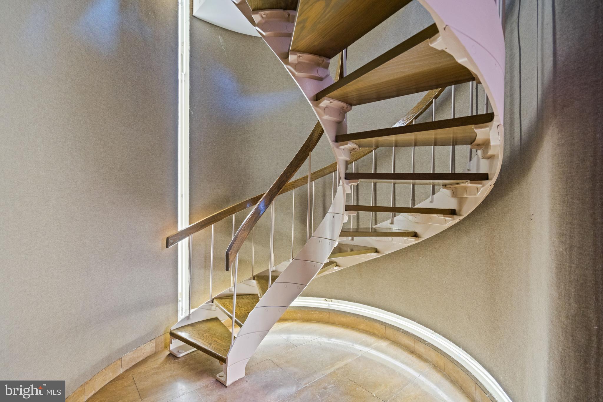901 26th Street Northwest Washington, DC 20037 - Photo 11 of 32 a view of staircase with wooden floor and white walls
