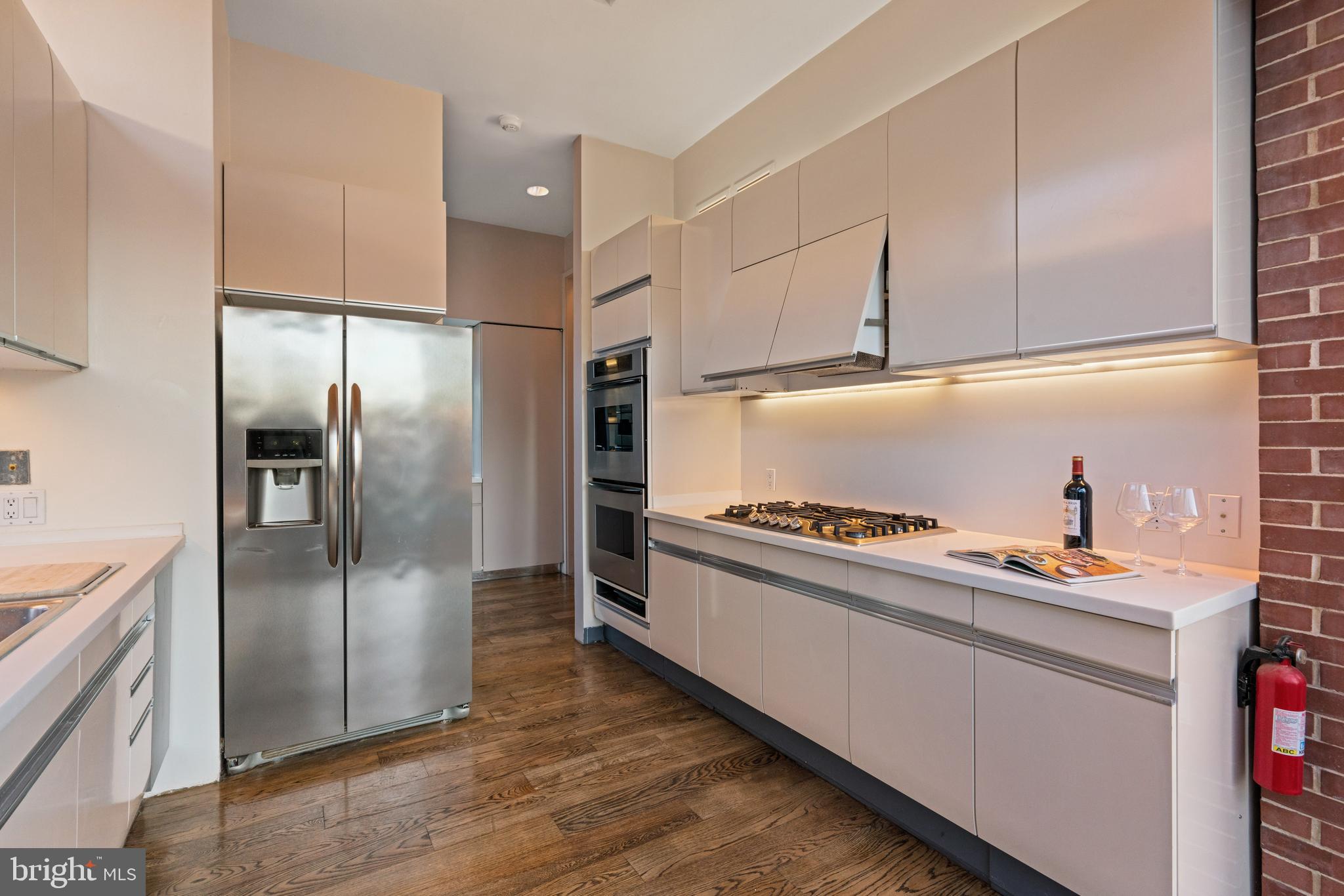 901 26th Street Northwest Washington, DC 20037 - Photo 19 of 32 a kitchen with stainless steel appliances granite countertop a refrigerator and a stove