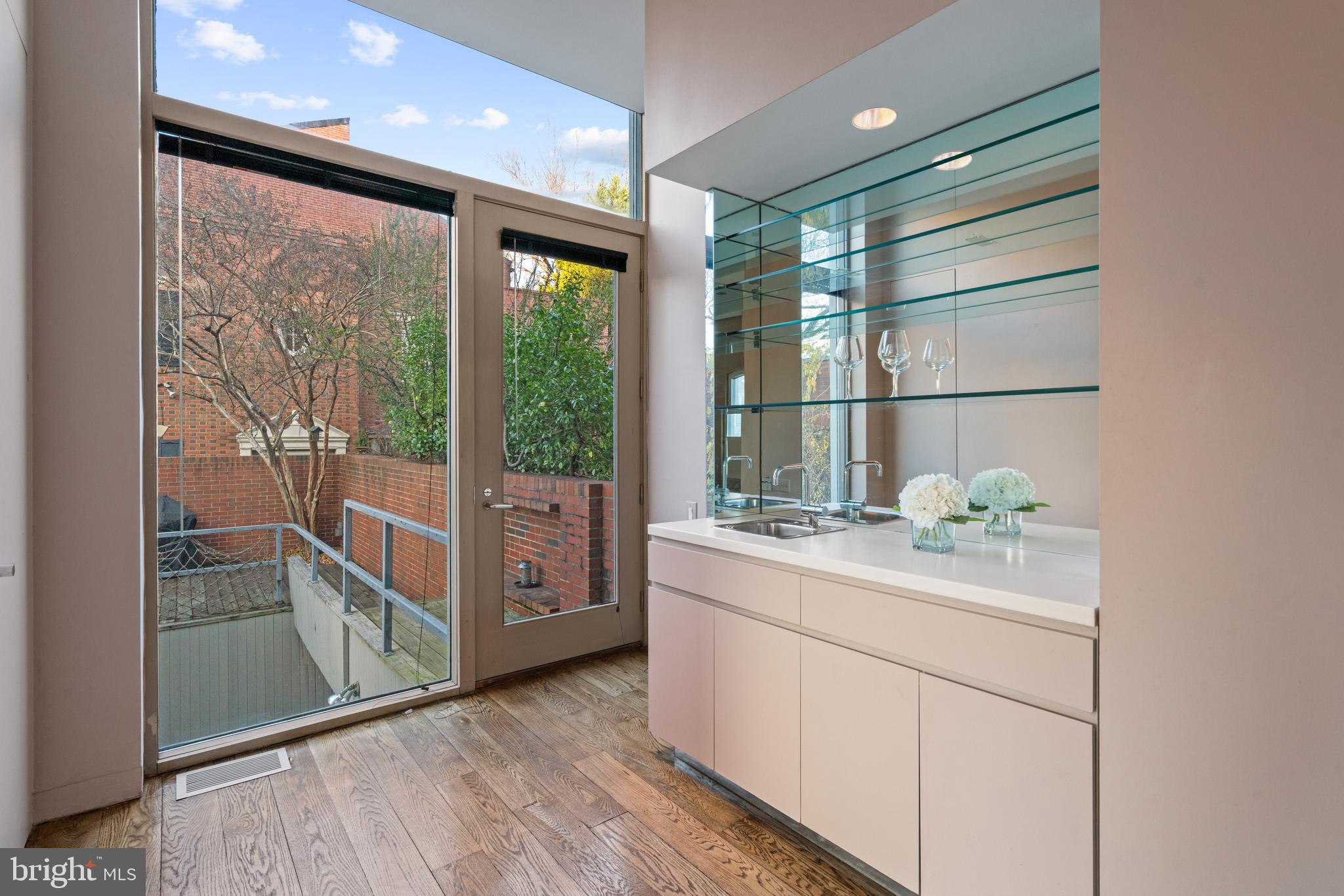 901 26th Street Northwest Washington, DC 20037 - Photo 20 of 32 a kitchen with a sink and wooden cabinets
