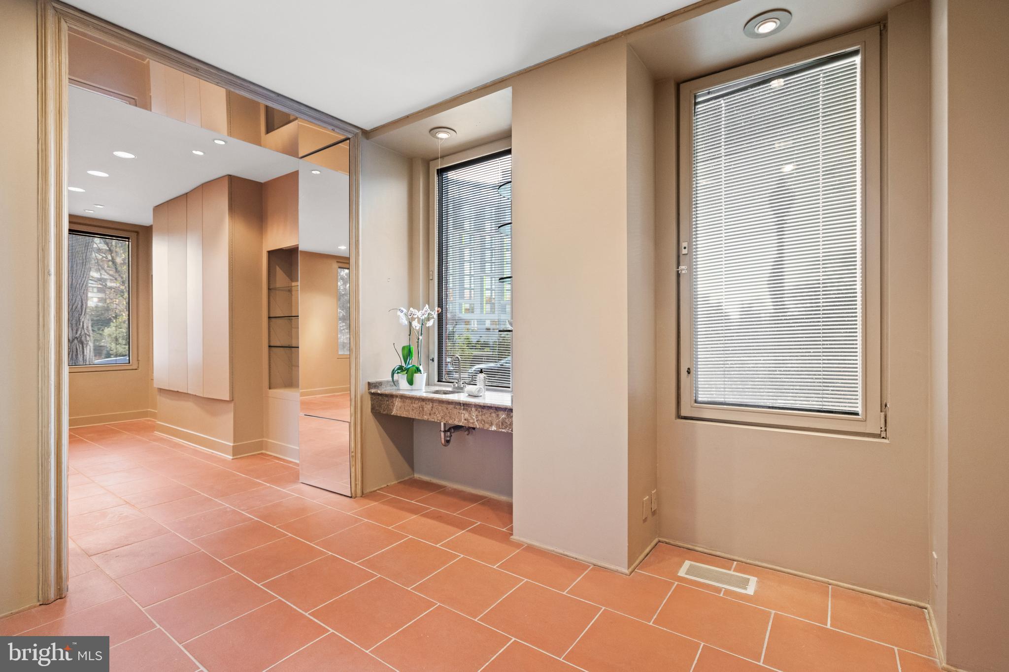 901 26th Street Northwest Washington, DC 20037 - Photo 4 of 32 a view of an empty room with a fireplace and a window