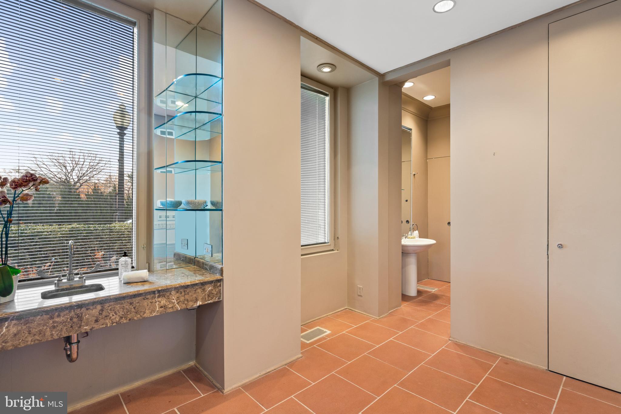 901 26th Street Northwest Washington, DC 20037 - Photo 7 of 32 a bathroom with a sink and a mirror