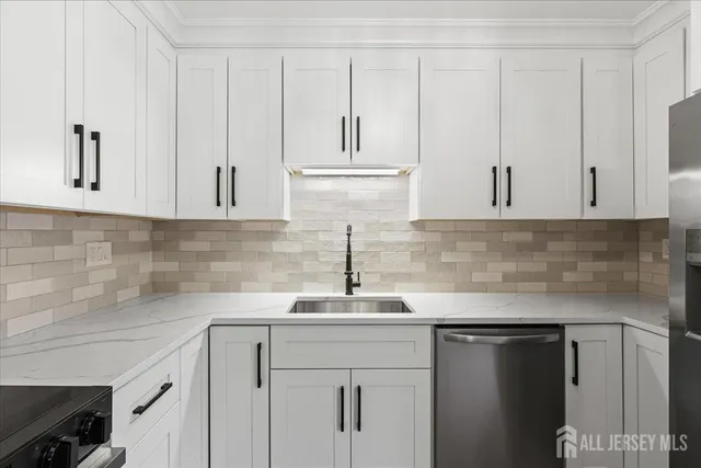 a kitchen with cabinets stainless steel appliances and wooden floor