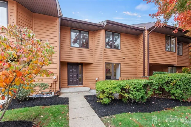 a front view of a house with a garden