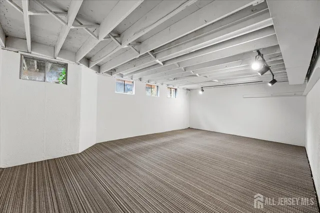 a view of a room with wooden floors