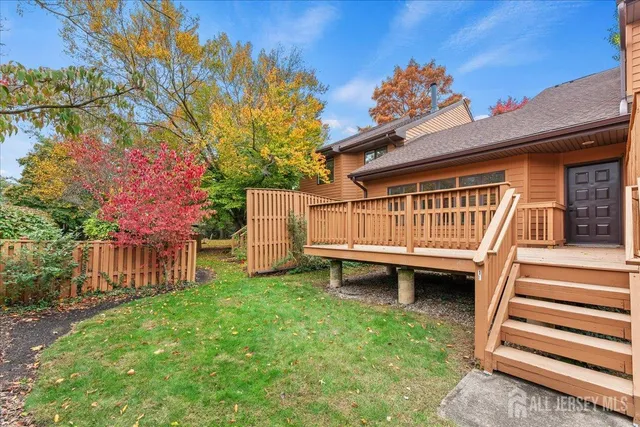 a view of a house with a yard and deck