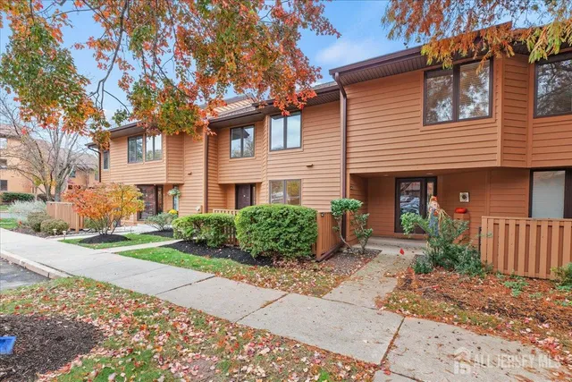 a front view of a house with garden and porch