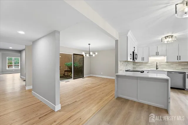 a large kitchen with kitchen island a sink stainless steel appliances and cabinets