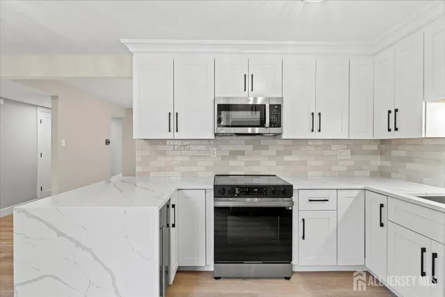 a kitchen with white cabinets and a sink