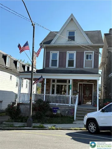 a view of a house with a yard and balcony