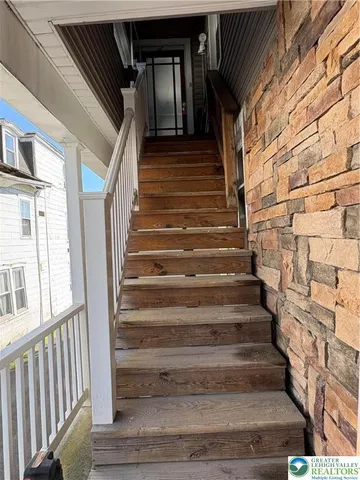 a view of entryway with wooden floor and stairs