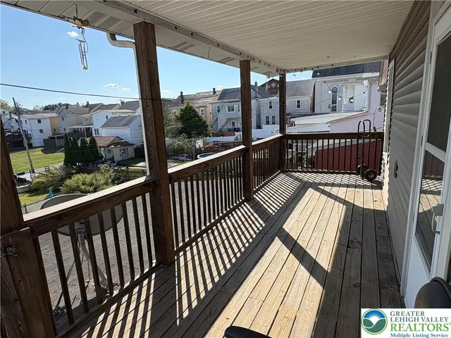 a view of balcony with wooden floor