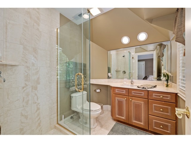 1415 Tyrell Avenue Park Ridge, IL 60068 - Photo 21 of 25 a bathroom with a granite countertop sink a toilet and a bathtub