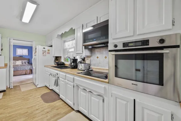 a bedroom with a bed gym equipment and a window