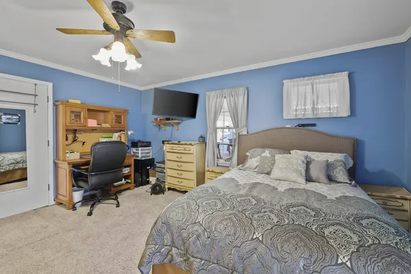 a bedroom with a bed and a chandelier