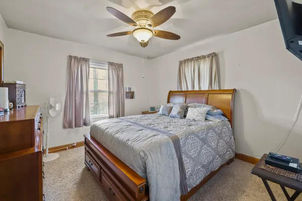 a bedroom with a bed and flat screen tv