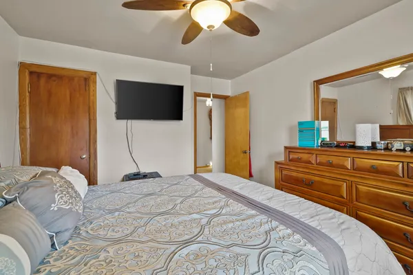 a living room with furniture a flat screen tv and a couch