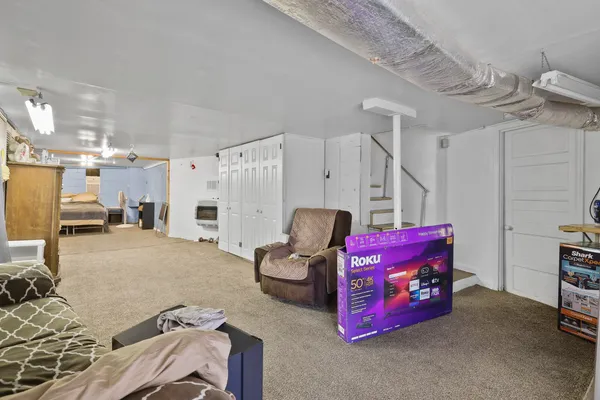 a bedroom with furniture and a window