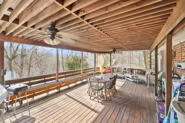 a kitchen with stainless steel appliances granite countertop a dining table chairs sink refrigerator and cabinets