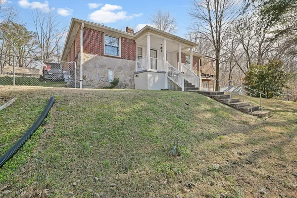a view of a brick house with a yard