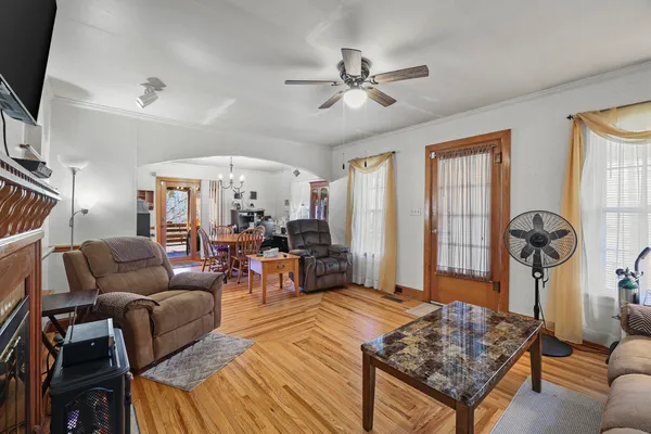 a view of a dining room with furniture a chandelier and wooden floor