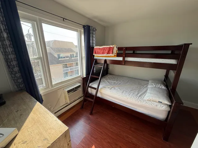 a living room with a bed furniture and a window