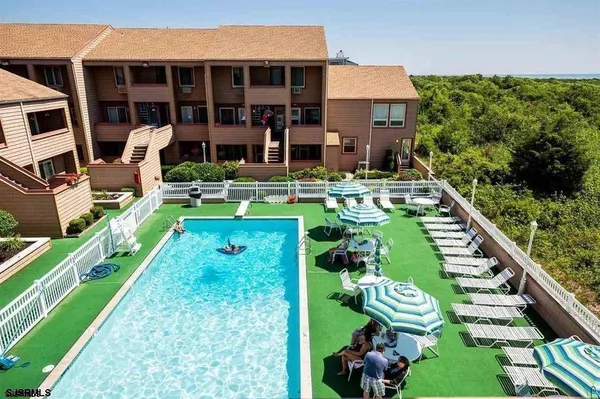 a view of a house with backyard sitting area and garden