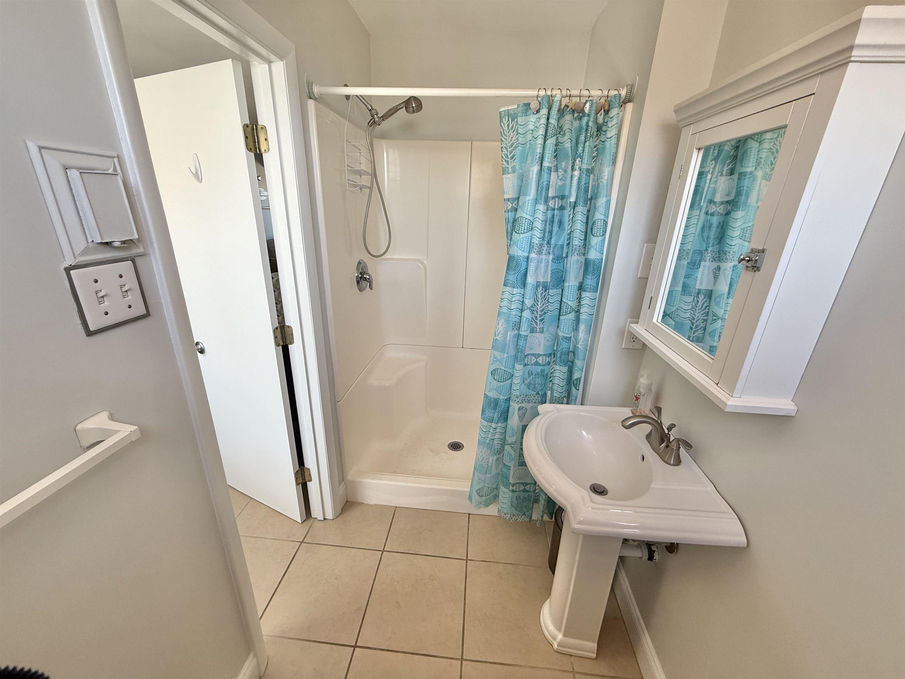 330 42nd Street South, Unit D49 Brigantine, NJ 08203 - Photo 9 of 23 a bathroom with a sink a toilet and shower