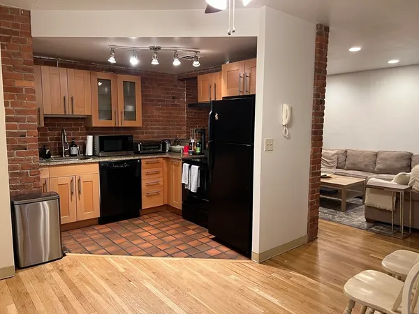 a kitchen with a refrigerator and a sink