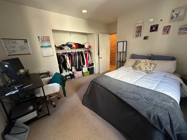 a bed room with a bed and a chair