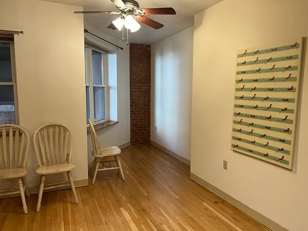 a view of a room with furniture and wooden floor