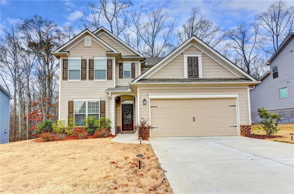 4230 Spring Ridge Drive Cumming, GA 30028 - Photo 1 of 1 a front view of a house with a yard and garage