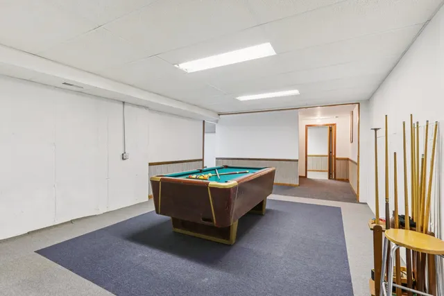 a living room with furniture a flat screen tv and a window