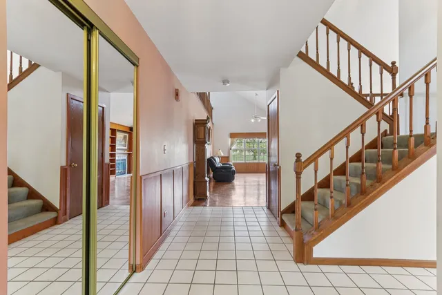 a view of staircase with lots of frames and a rug