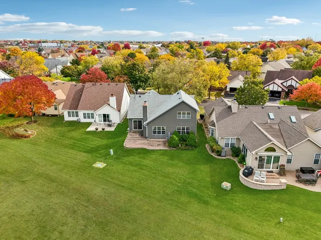 an aerial view of a house with swimming pool garden and patio