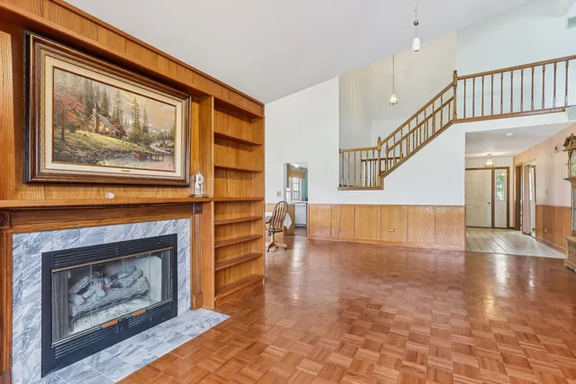 a view of main area with staircase and fireplace