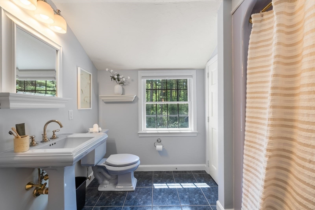 49 Walpole Street Dover, MA 02030 - Photo 25 of 40 a bathroom with a sink a toilet and a window