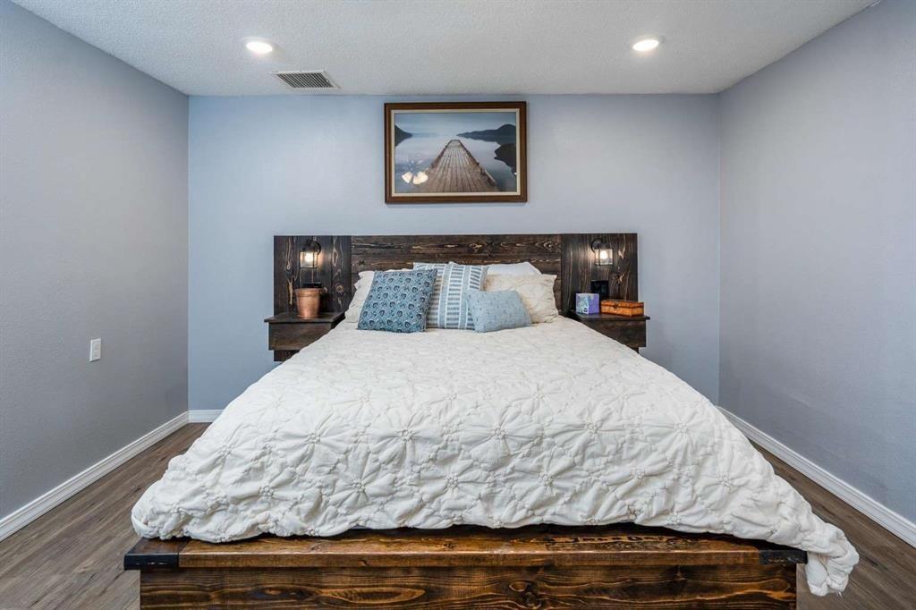 365 Co Road Stamford, TX 79553 - Photo 19 of 23 Wood-finish flooring, recessed lighting, and light blue wall color