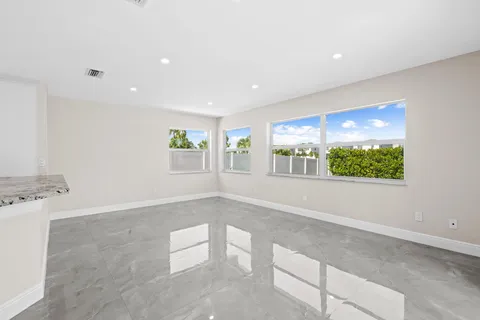 a view of kitchen with stainless steel appliances refrigerator oven and cabinets
