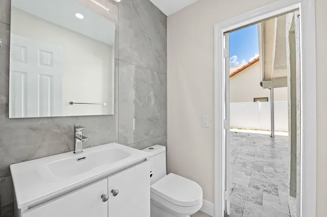 a spacious bathroom with a shower sink and mirror